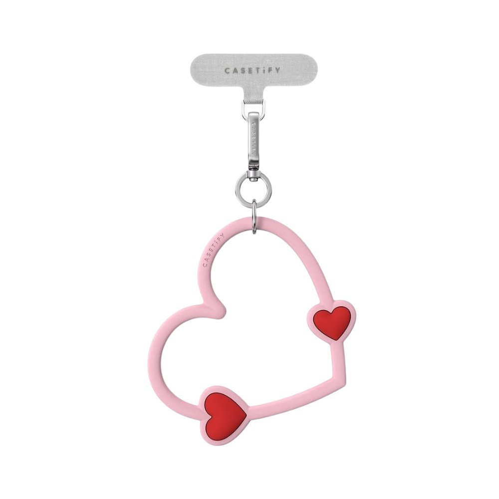 Accesorio CASETiFY strap de mano corazon rosado